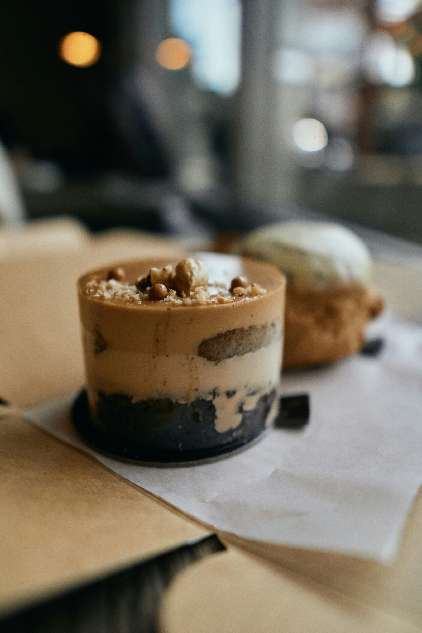 white and brown ice cream on black ceramic bowl