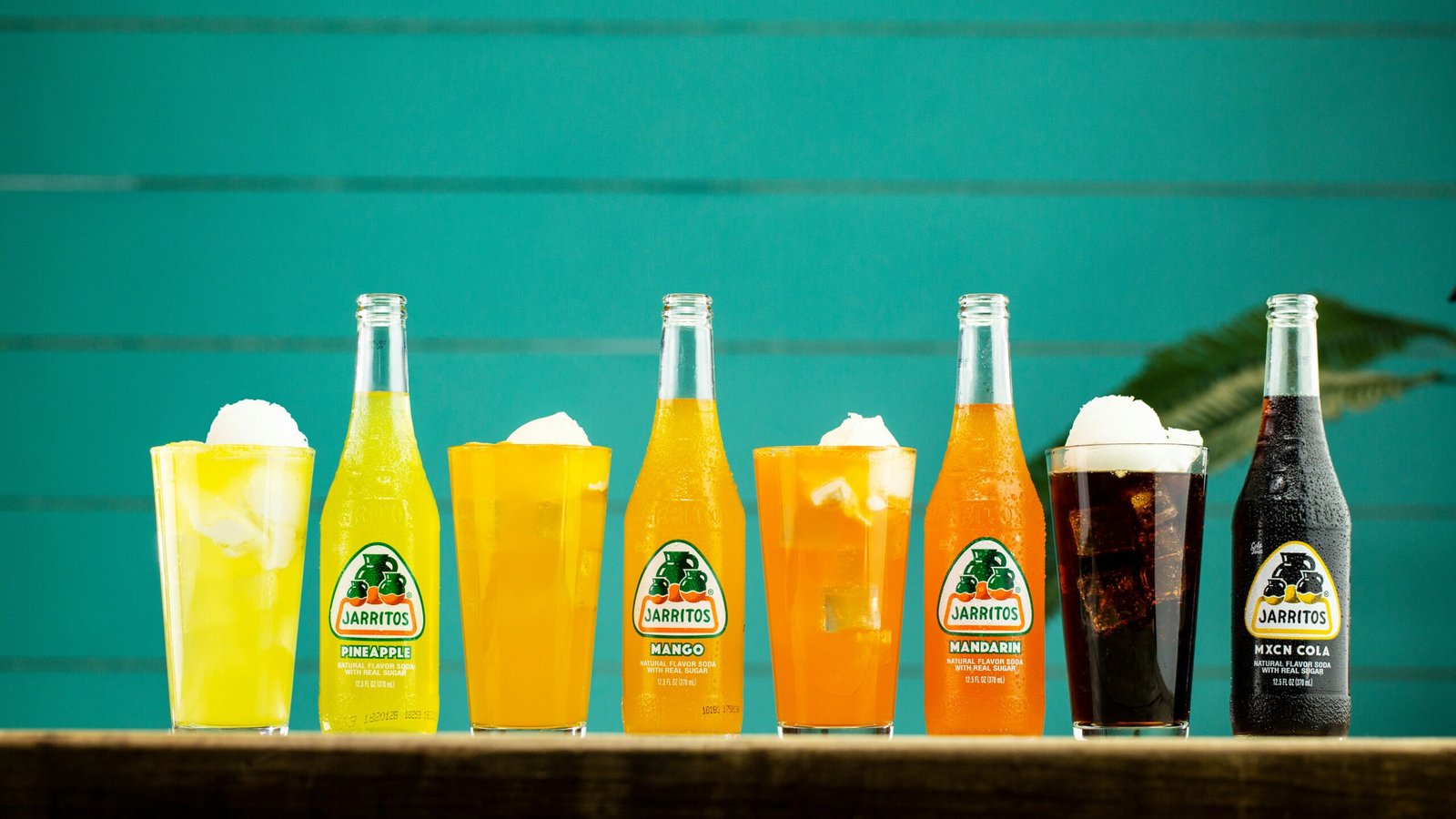 three orange juice bottles on shelf